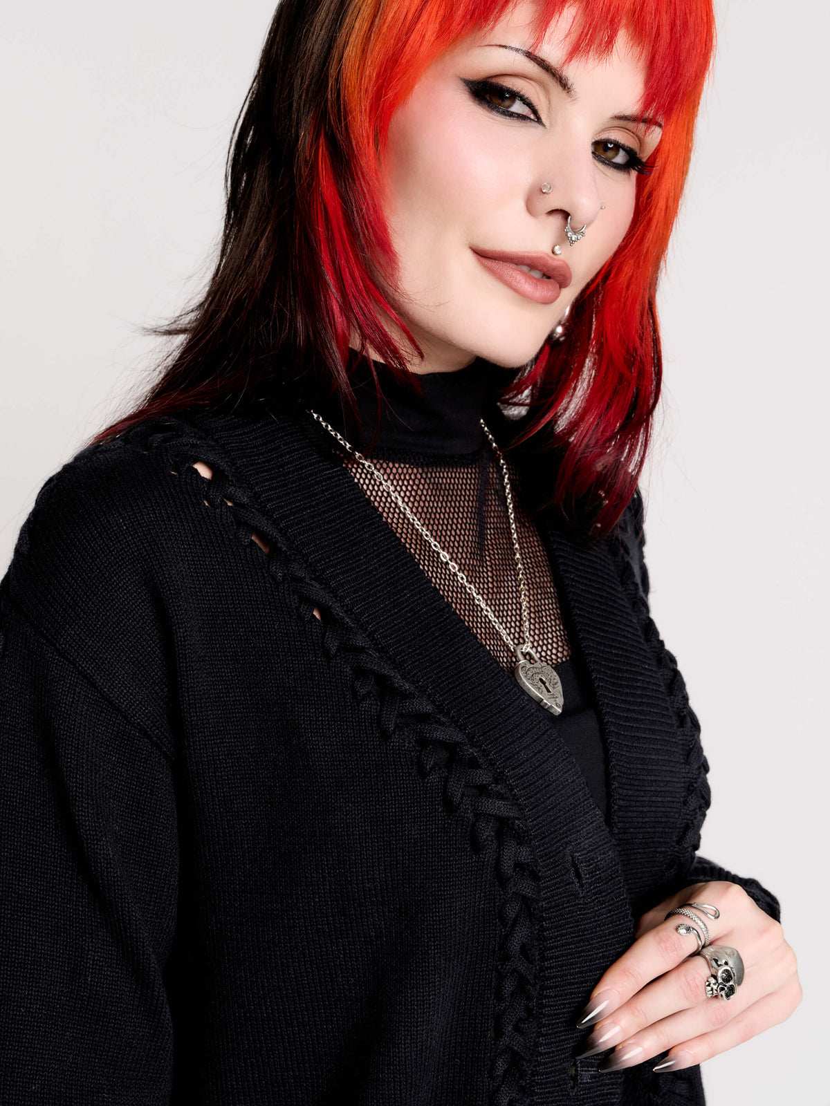 a black knit cardigan with braided details