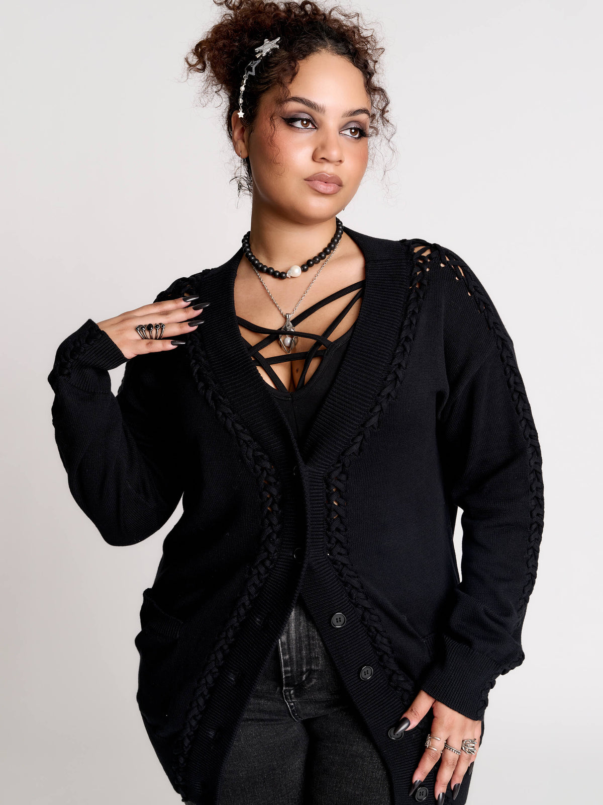 a black knit cardigan with braided details