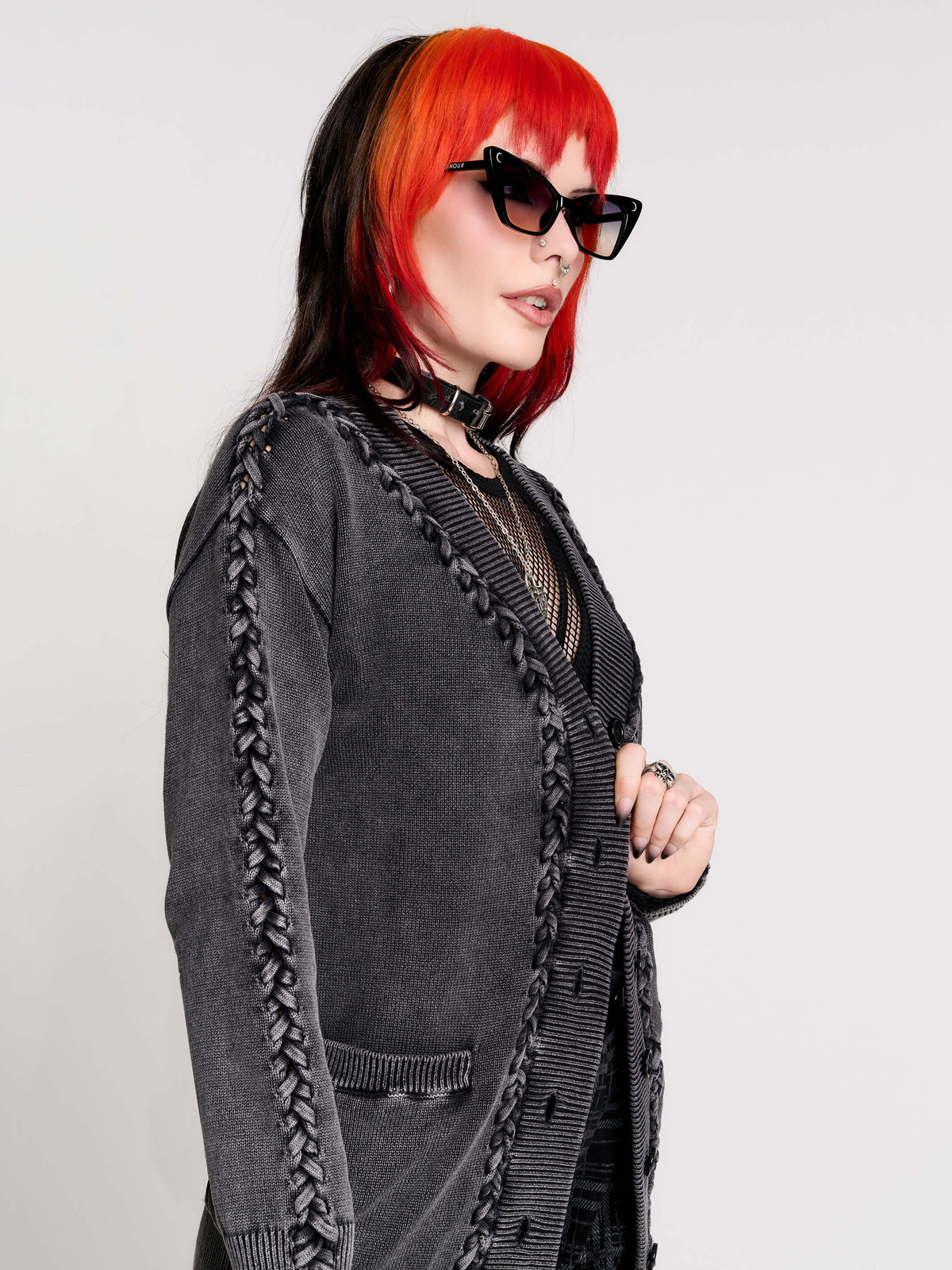 a dark gray textured cardigan with braided details