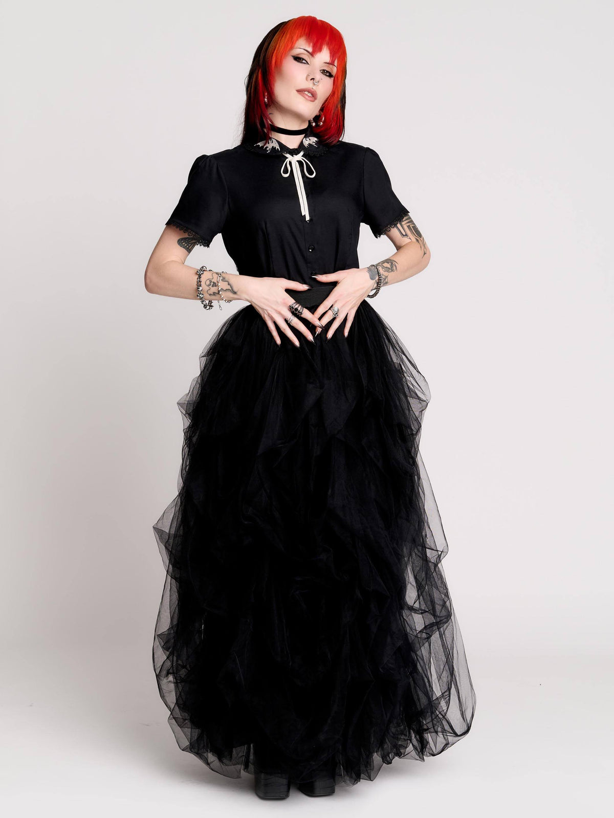 black short-sleeve blouse with white embroidered bat on collar and black lace trim