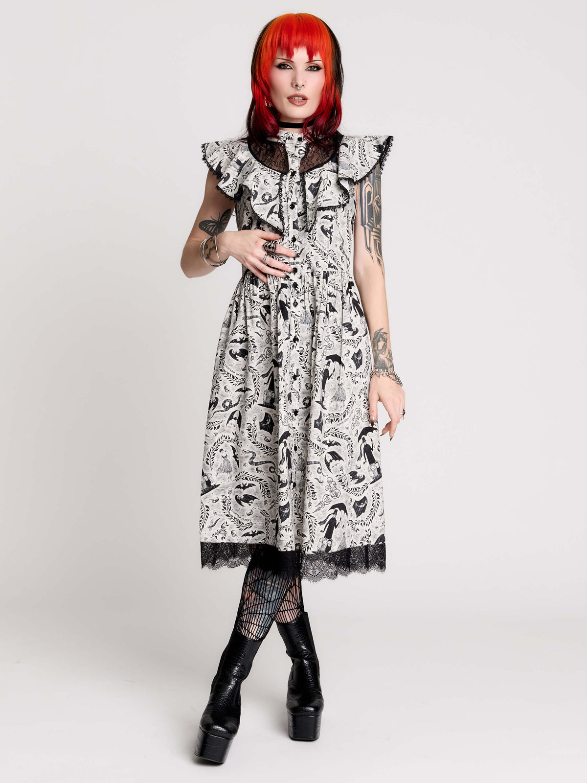 black and white gothic-style dress with a bird pattern, lace trim, and a high ruffled collar