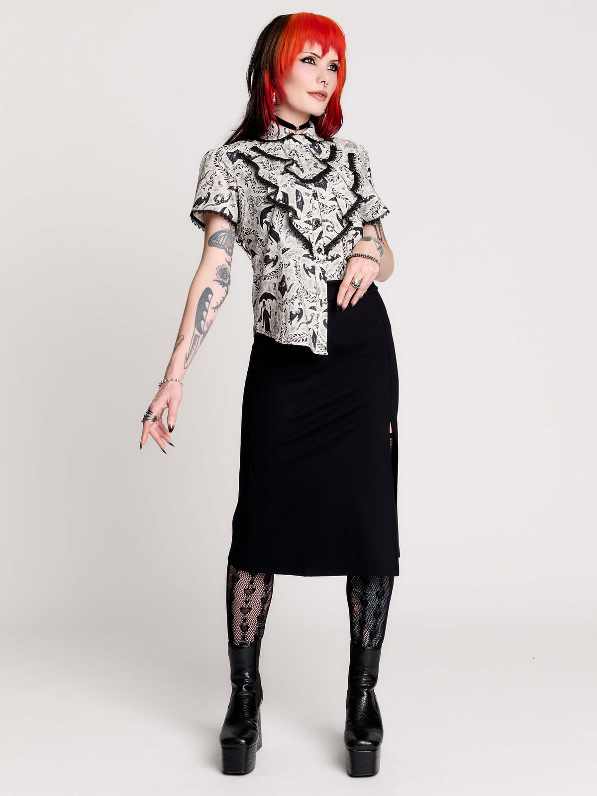 a black and white patterned ruffled blouse