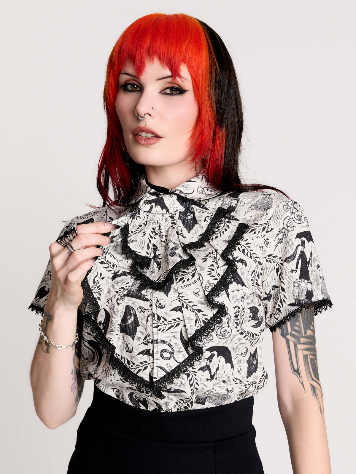 a black and white patterned ruffled blouse
