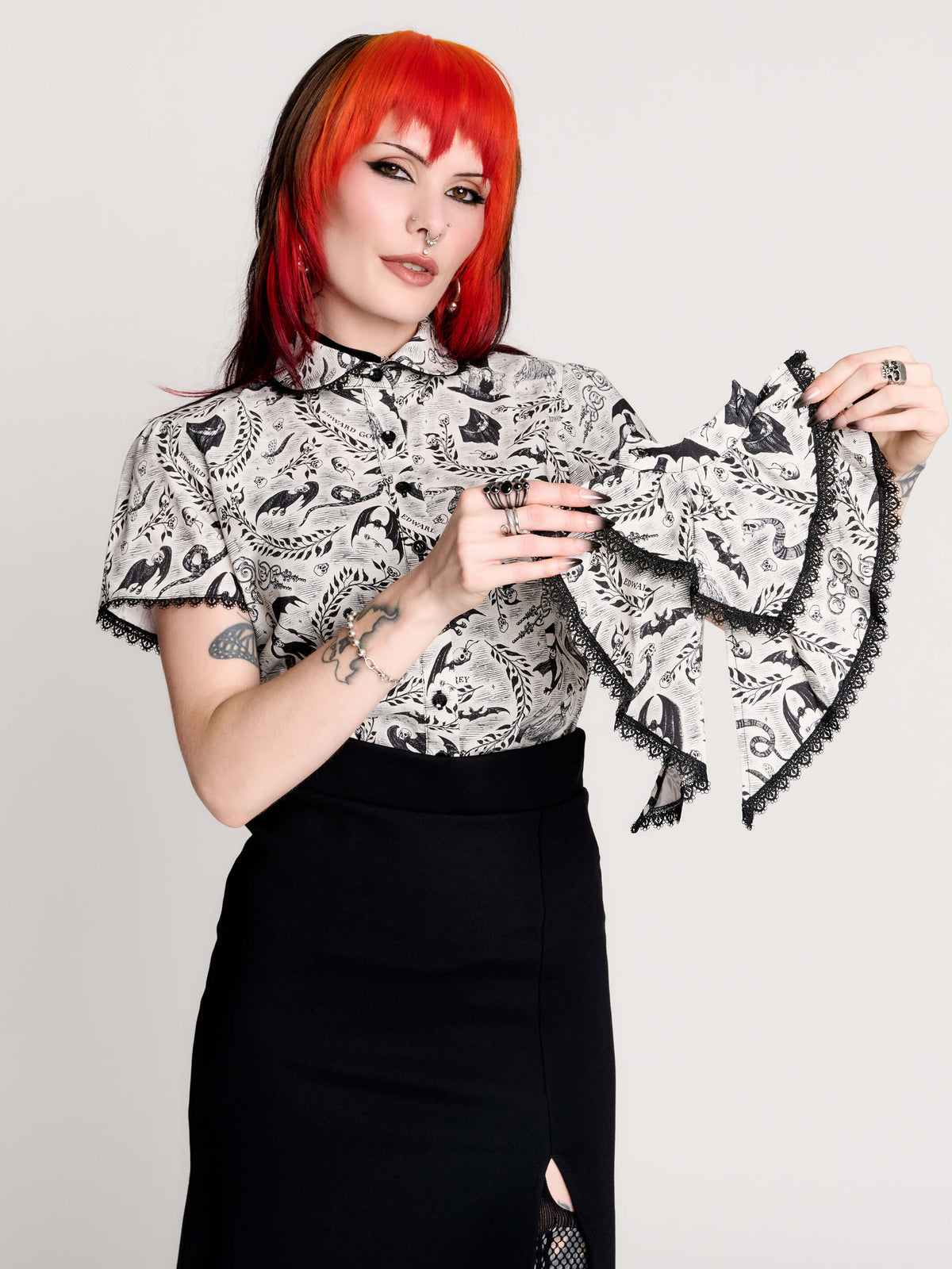 a black and white patterned ruffled blouse