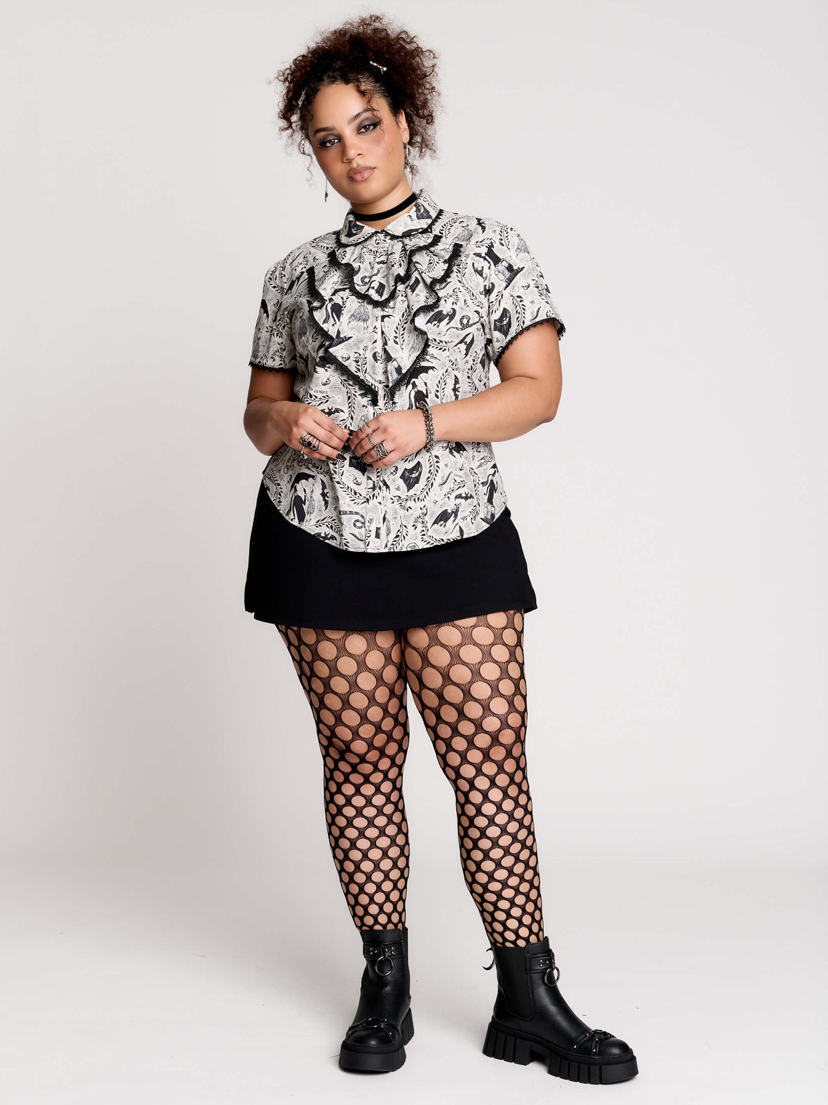 a black and white patterned ruffled blouse