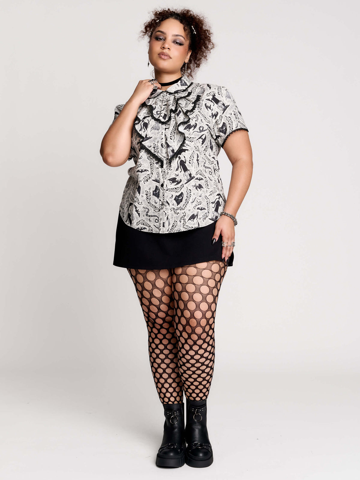 a black and white patterned ruffled blouse