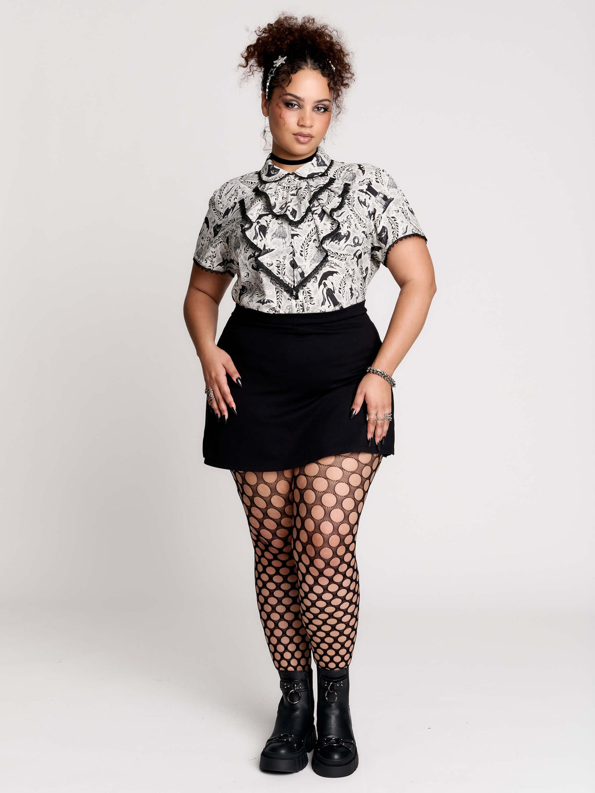 a black and white patterned ruffled blouse
