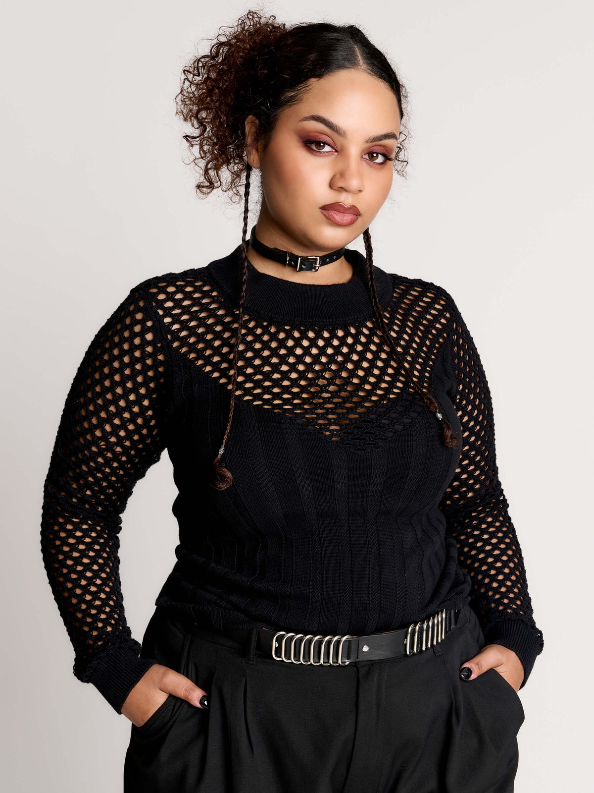 Fishnet Sweetheart Rib Sweater, a black long-sleeve top with a fitted rib-knit body and fishnet across the upper chest, shoulders, upper back and sleeves, giving a “sweetheart” illusion while keeping the sleek silhouette sleek.