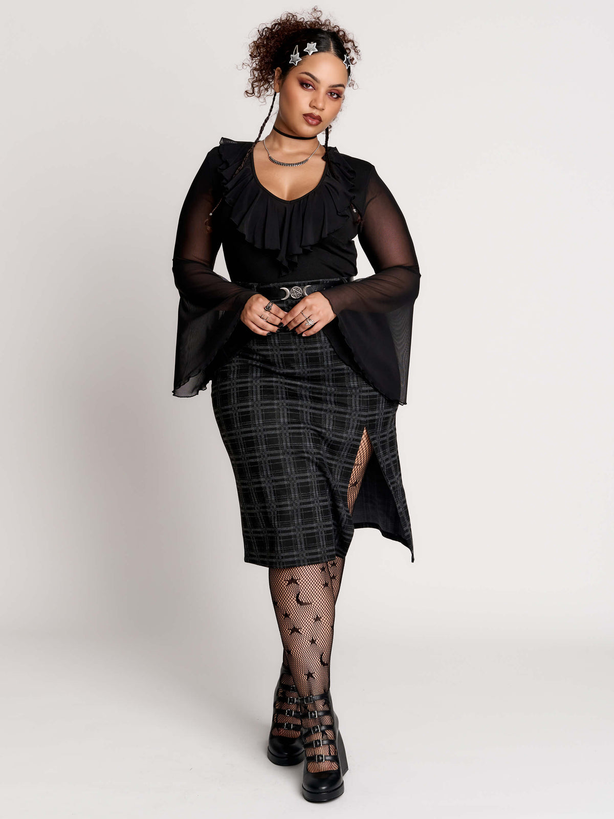 a black and gray plaid midi skirt with a front slit,