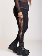 Stretchy cotton spandex leggings with slashed and braided side details.