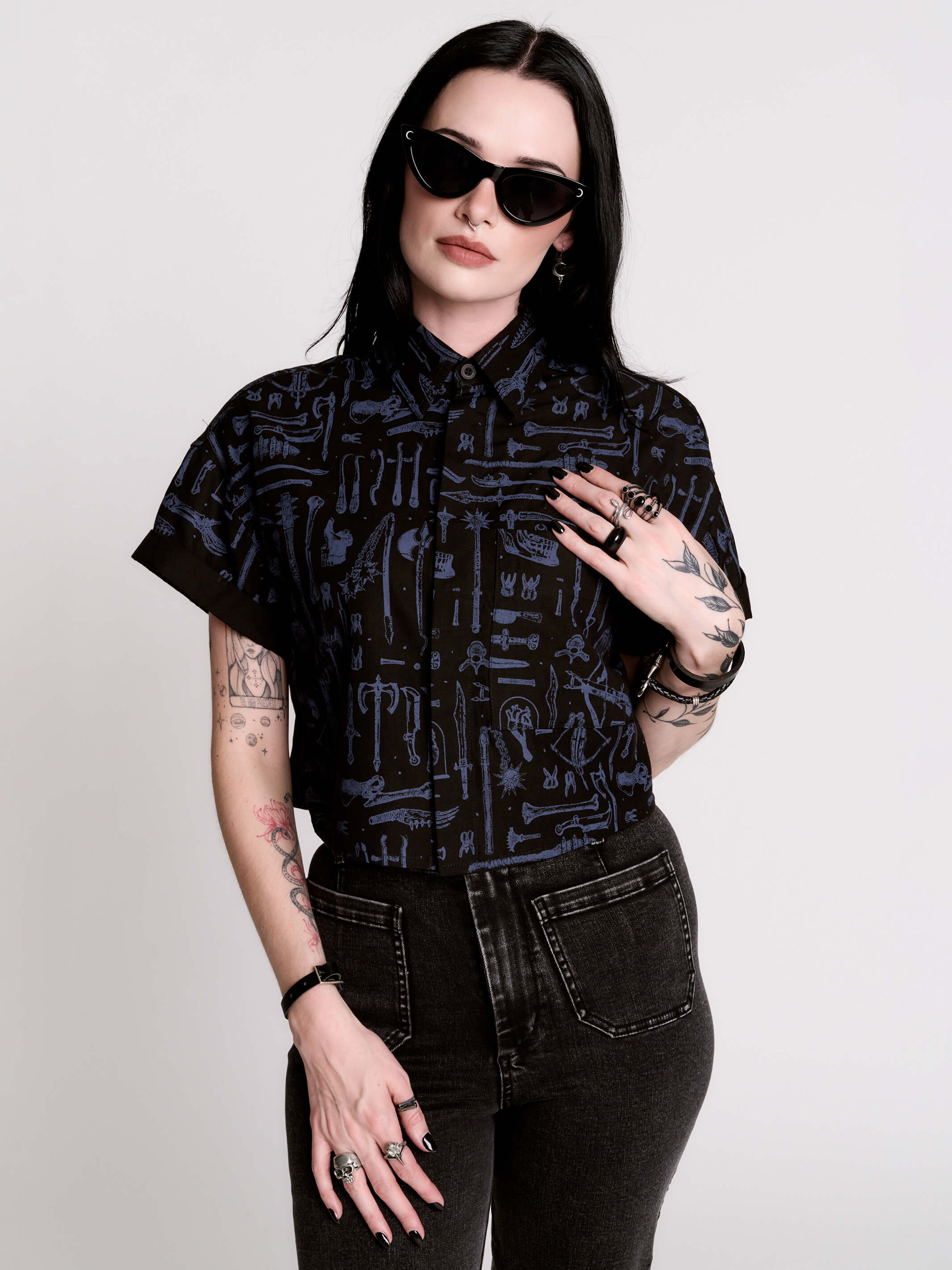 Armory Cropped Shirt is a boxy, cropped, short-sleeve button-down that mixes crisp classic shirting with dark, gothic illustration.