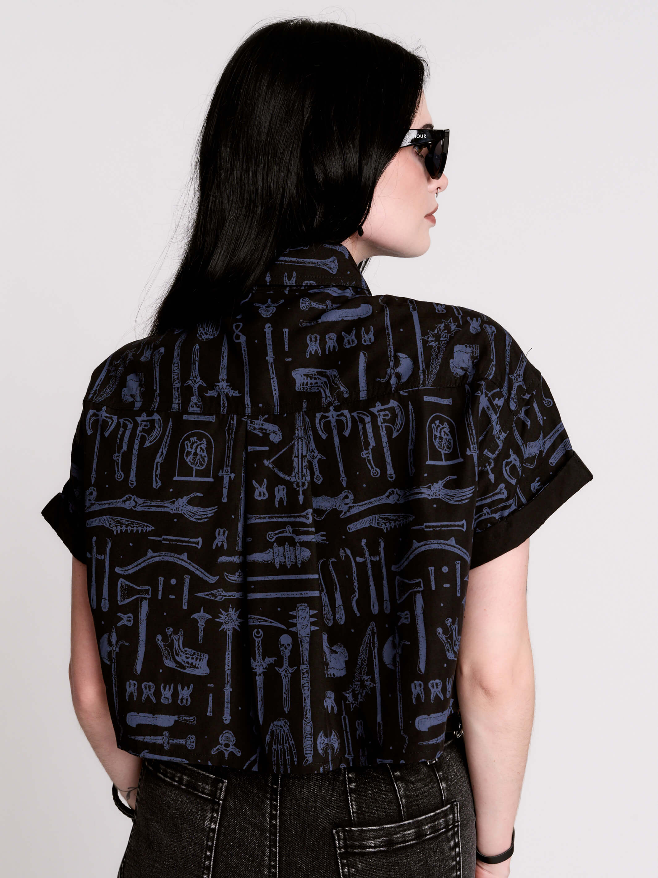 Armory Cropped Shirt is a boxy, cropped, short-sleeve button-down that mixes crisp classic shirting with dark, gothic illustration.