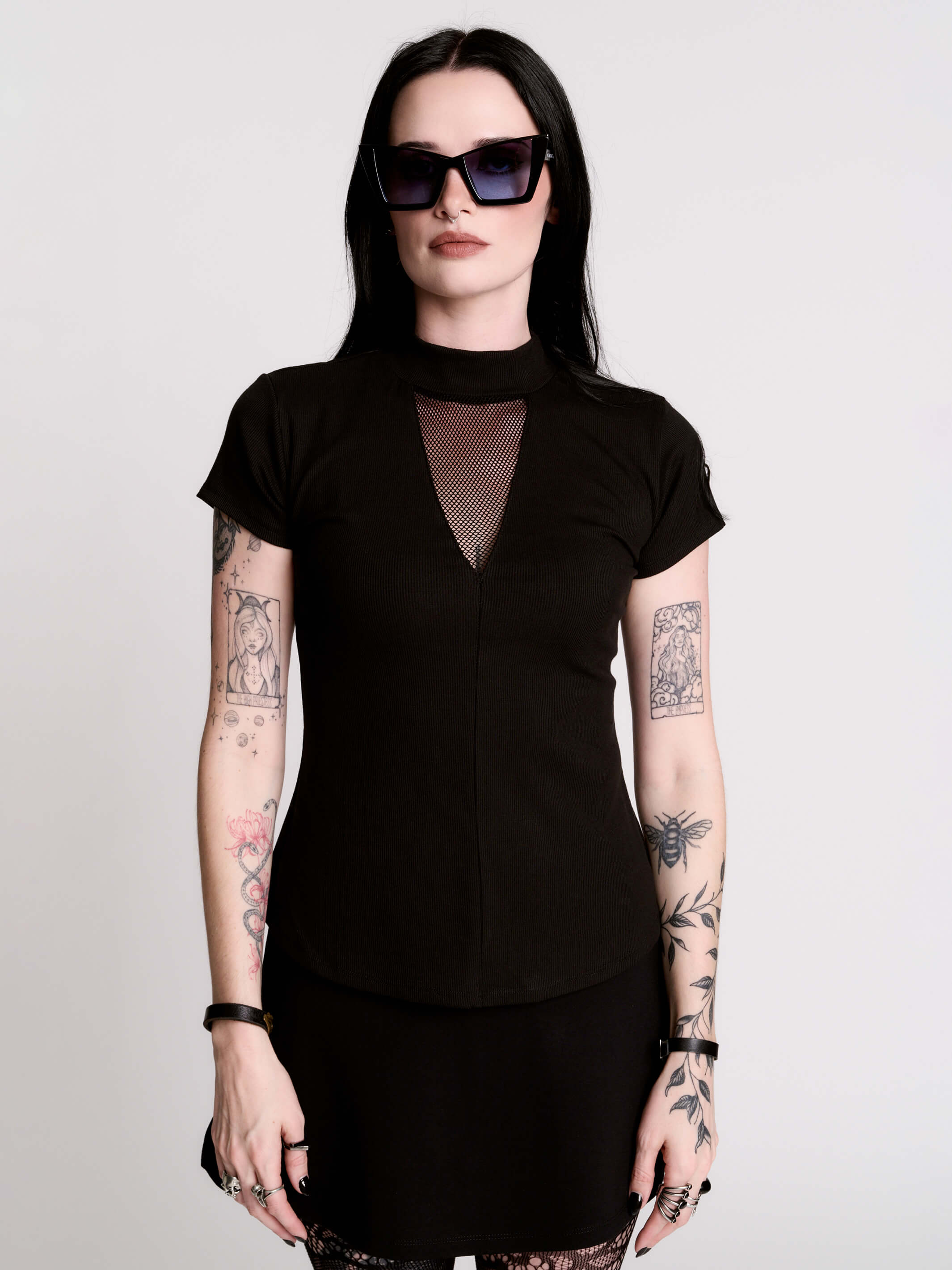 A black short-sleeve mock neck top with a fishnet mesh chest panel.