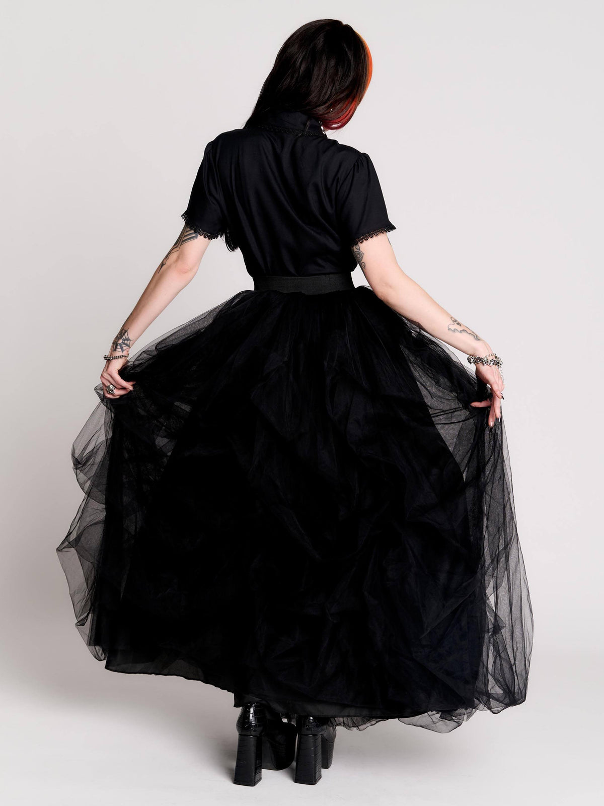 a voluminous layered black tulle skirt.