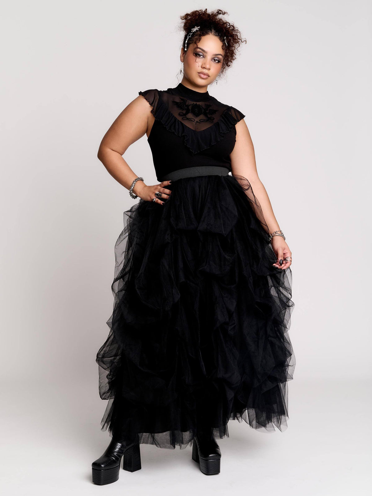 a voluminous layered black tulle skirt.