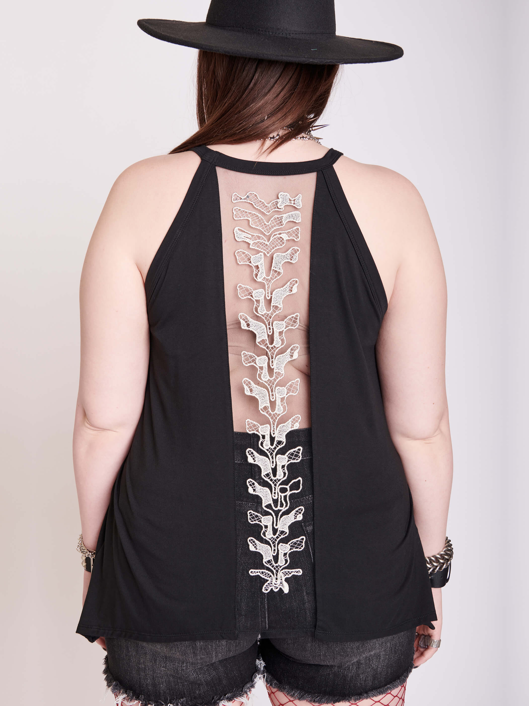 black tank with sheer back panel embroidered with spine motif