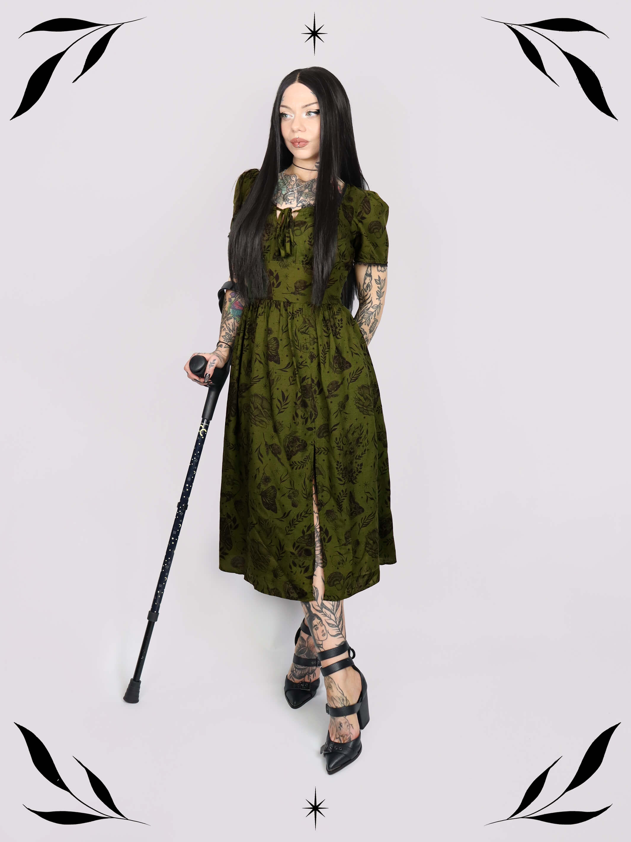a short-sleeved olive green midi dress with a gothic pattern