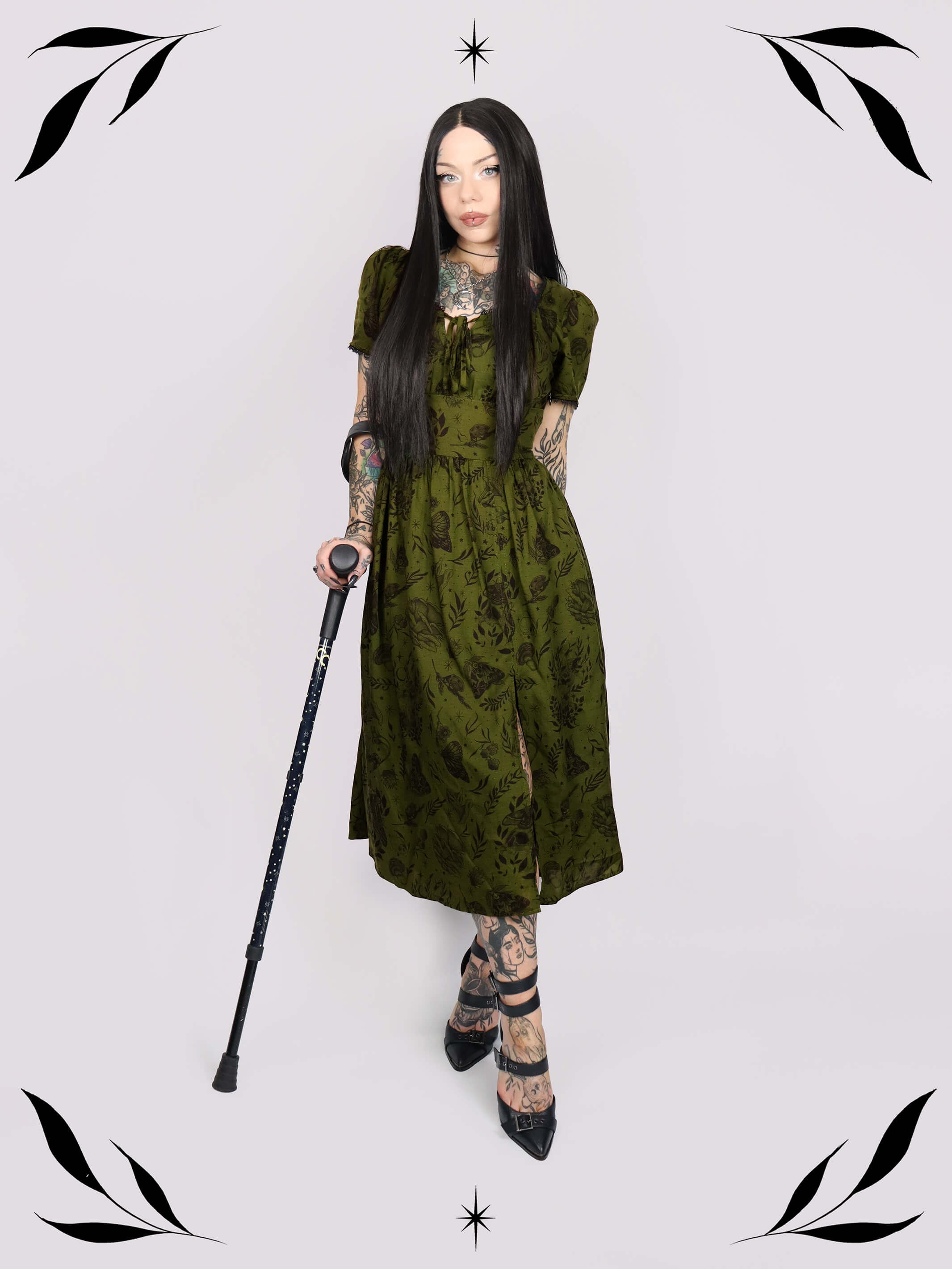a short-sleeved olive green midi dress with a gothic pattern