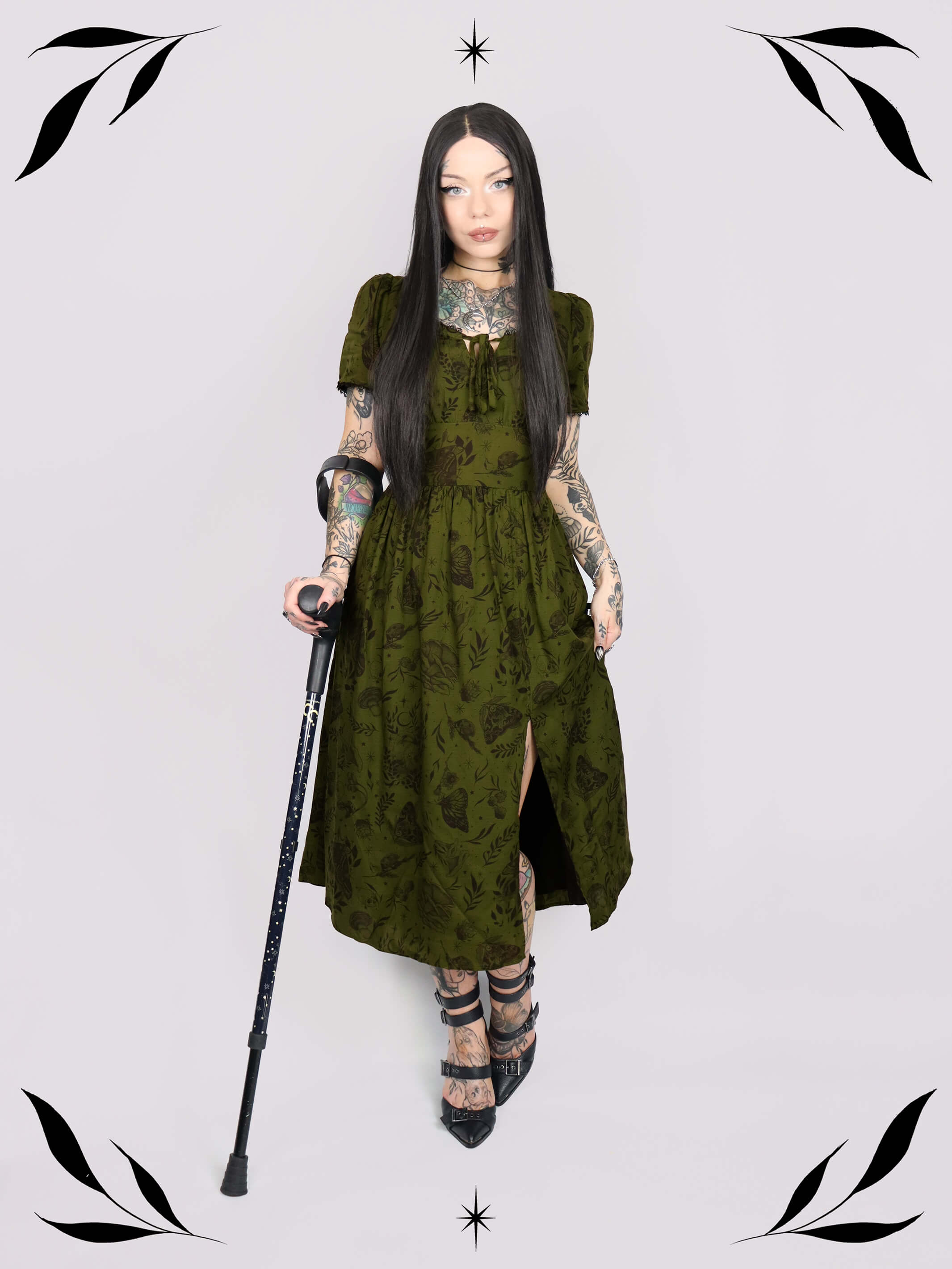 a short-sleeved olive green midi dress with a gothic pattern