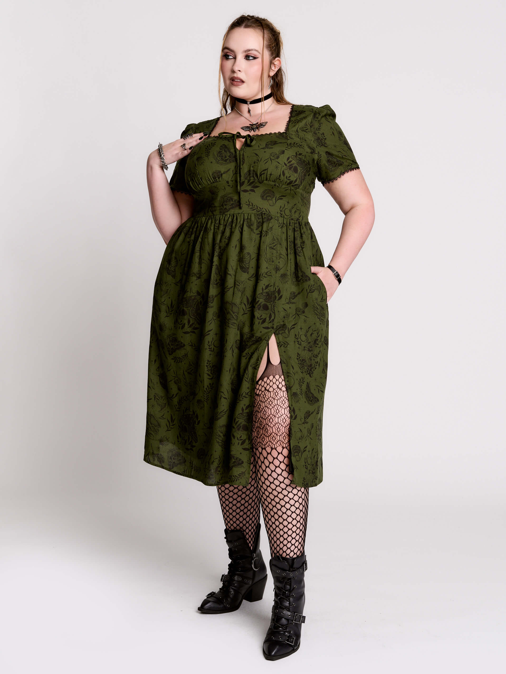 a short-sleeved olive green midi dress with a gothic pattern