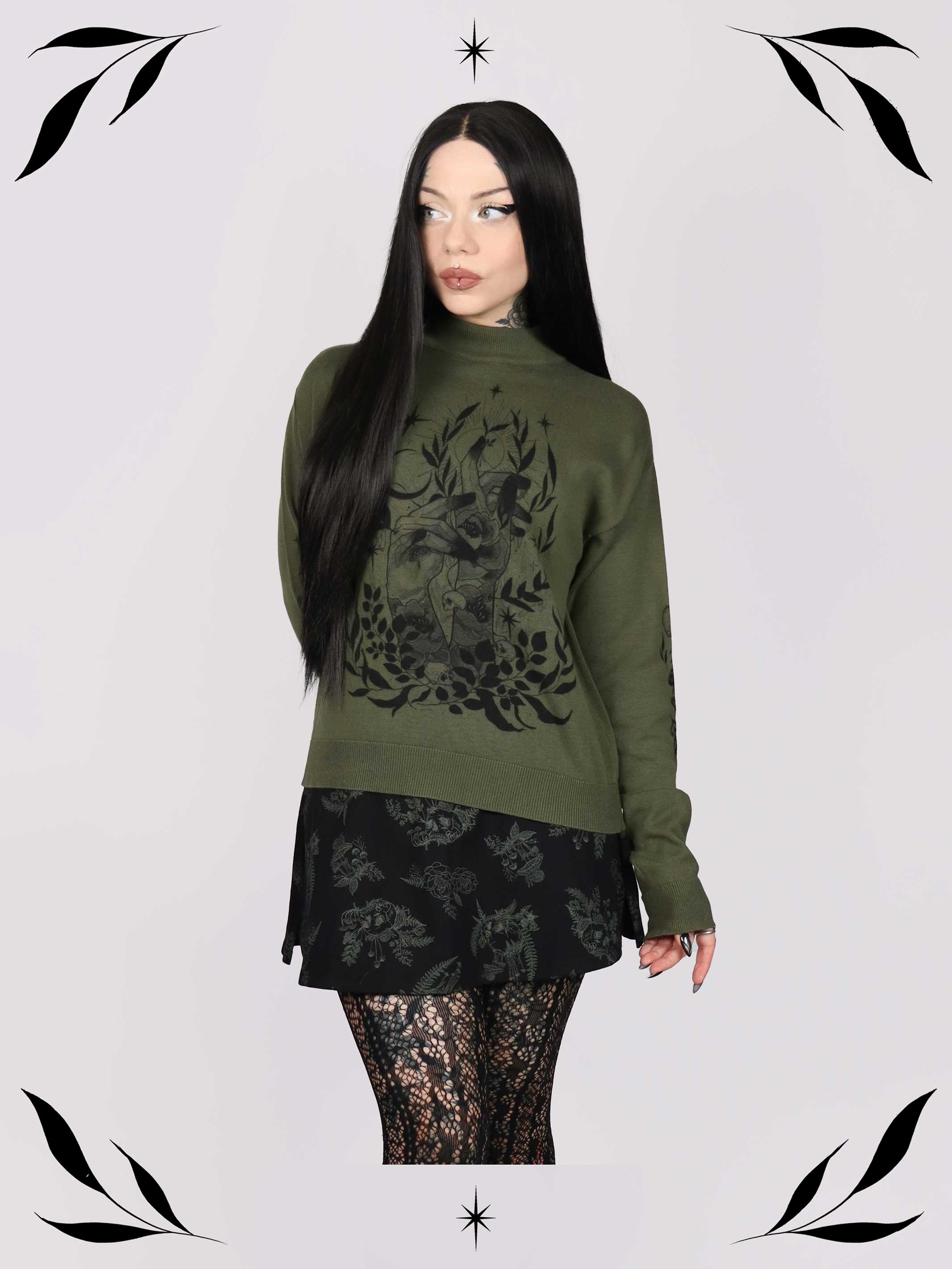an olive green mock-neck sweater featuring a black gothic graphic