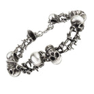 Silver bracelet with skull and barbed wire designs.