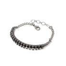 Silver spine inspired bracelet on a white background