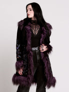 This mid-length black coat pairs a soft, suede-like finish with plush amethyst-purple faux fur trim