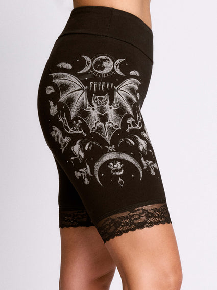 a person wearing black shorts with a bat design