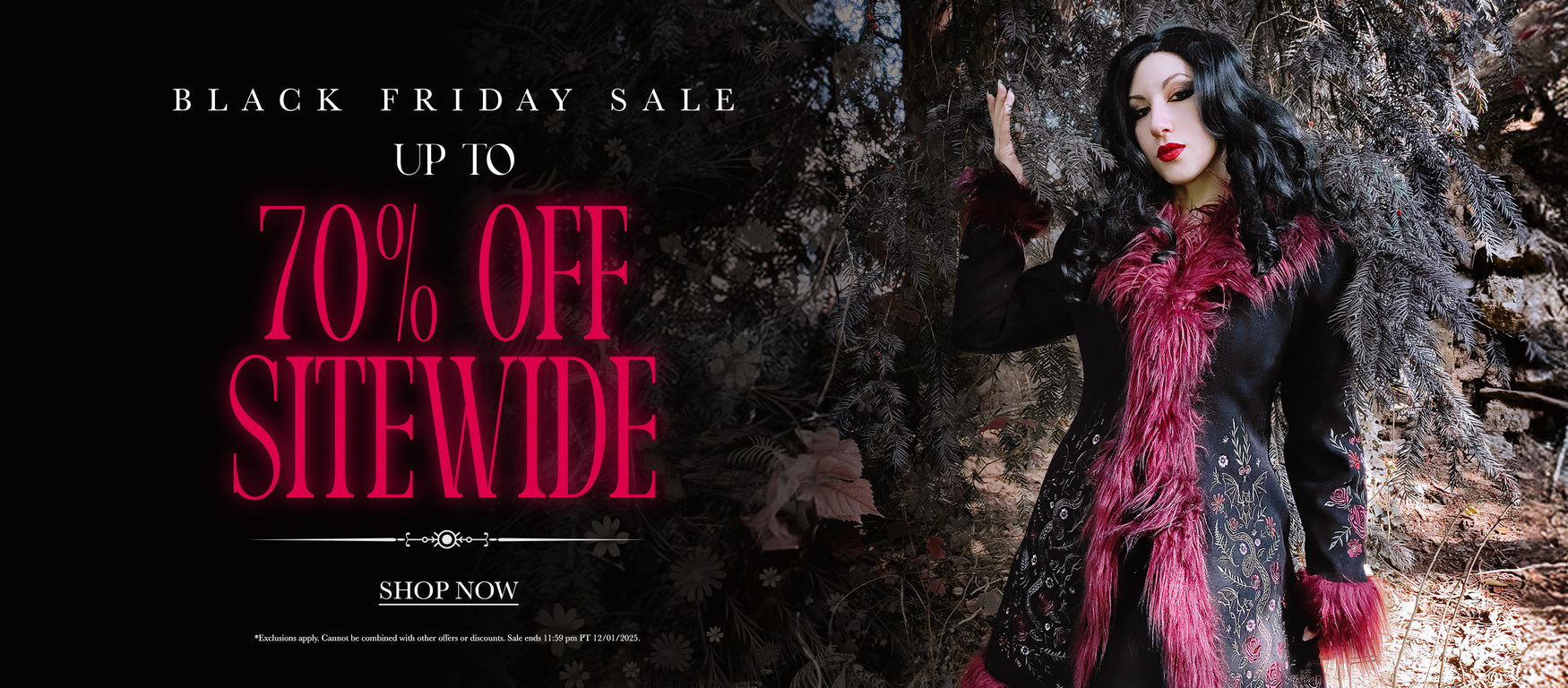 a woman in a black dress with pink hair