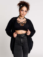 a black knit cardigan with braided details