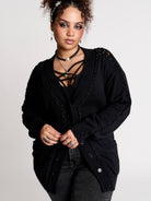 a black knit cardigan with braided details