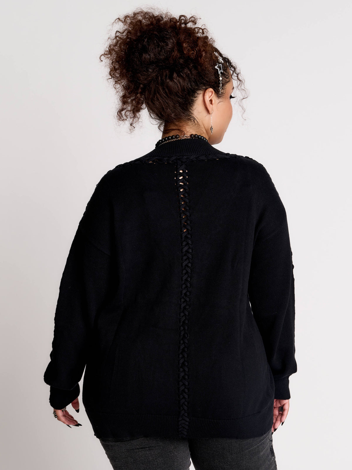a black knit cardigan with braided details