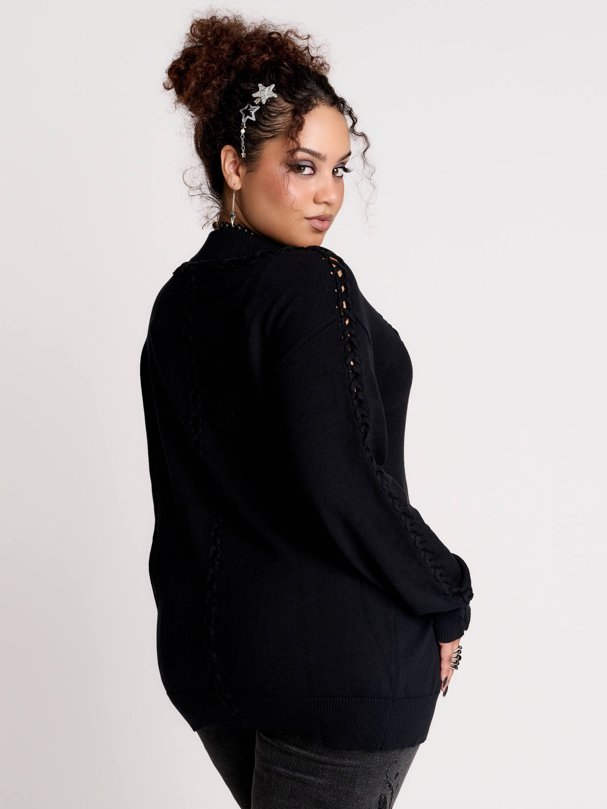a black knit cardigan with braided details