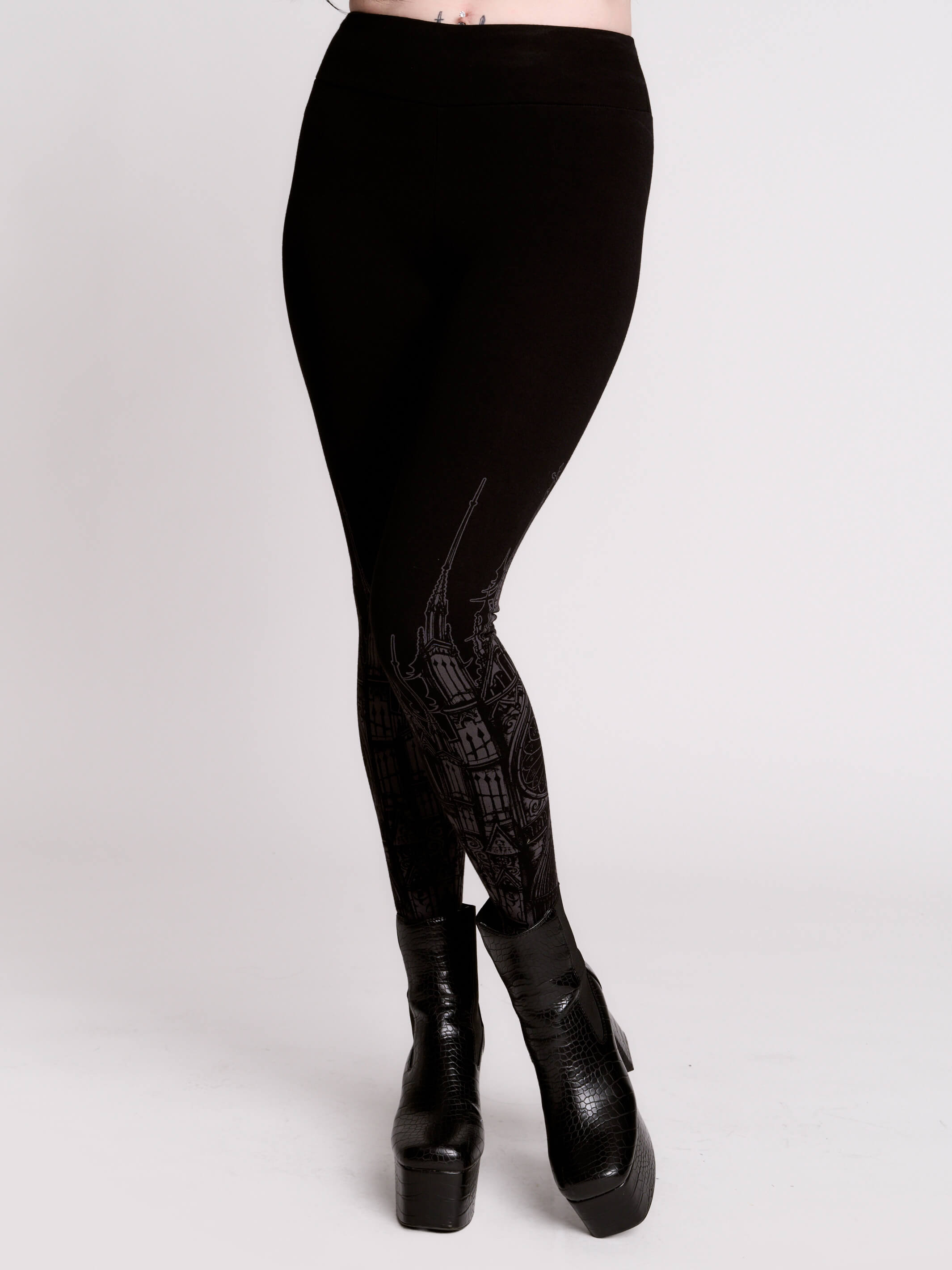 Black leggings with a dark gray gothic cathedral line-art print down the legs.