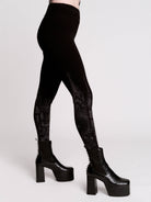 Black leggings with a dark gray gothic cathedral line-art print down the legs.