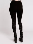 Black leggings with a dark gray gothic cathedral line-art print down the legs.