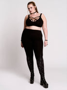 Black leggings with a dark gray gothic cathedral line-art print down the legs.