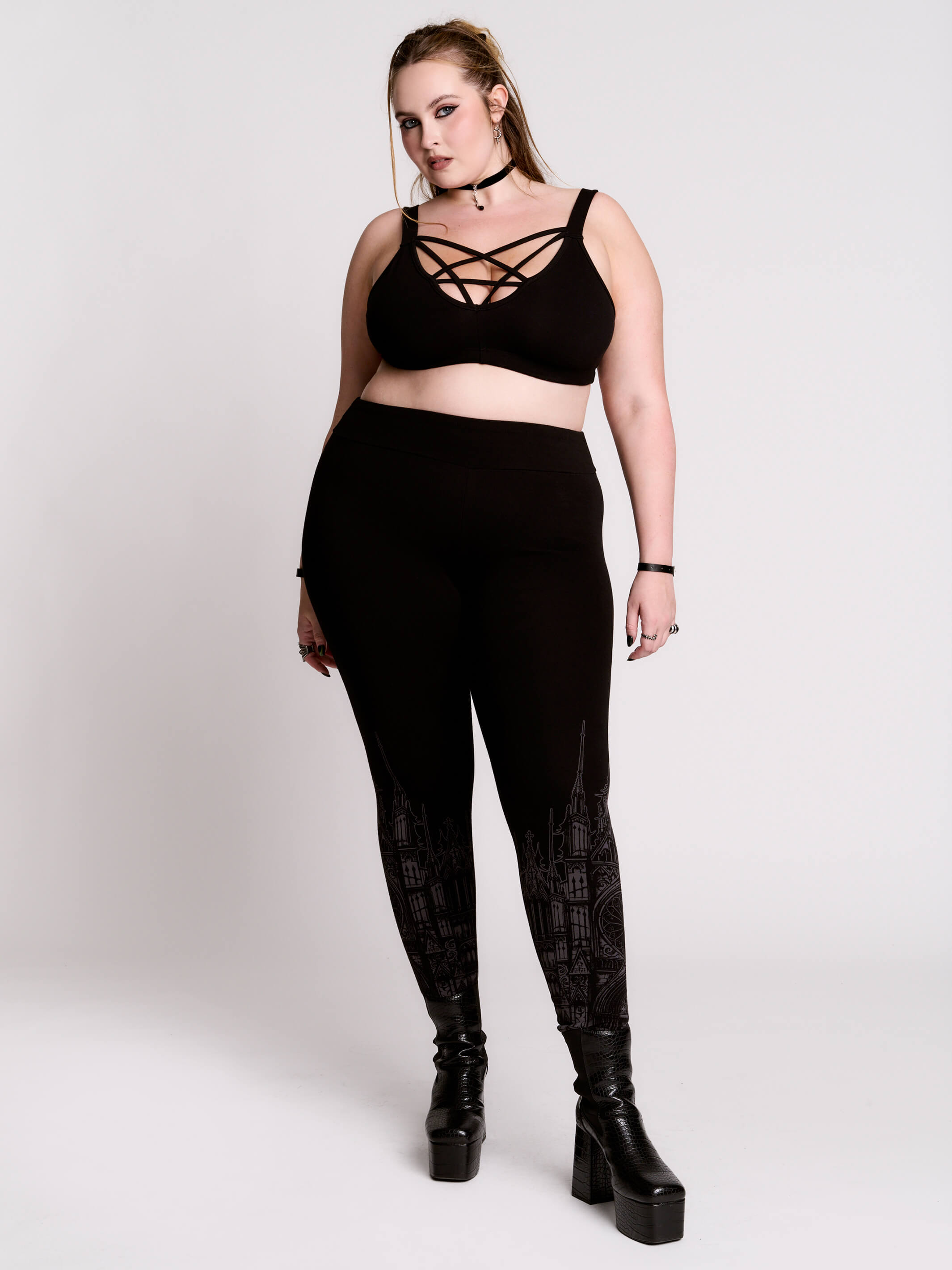 Black leggings with a dark gray gothic cathedral line-art print down the legs.