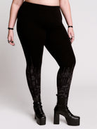 Black leggings with a dark gray gothic cathedral line-art print down the legs.