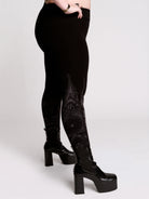 Black leggings with a dark gray gothic cathedral line-art print down the legs.