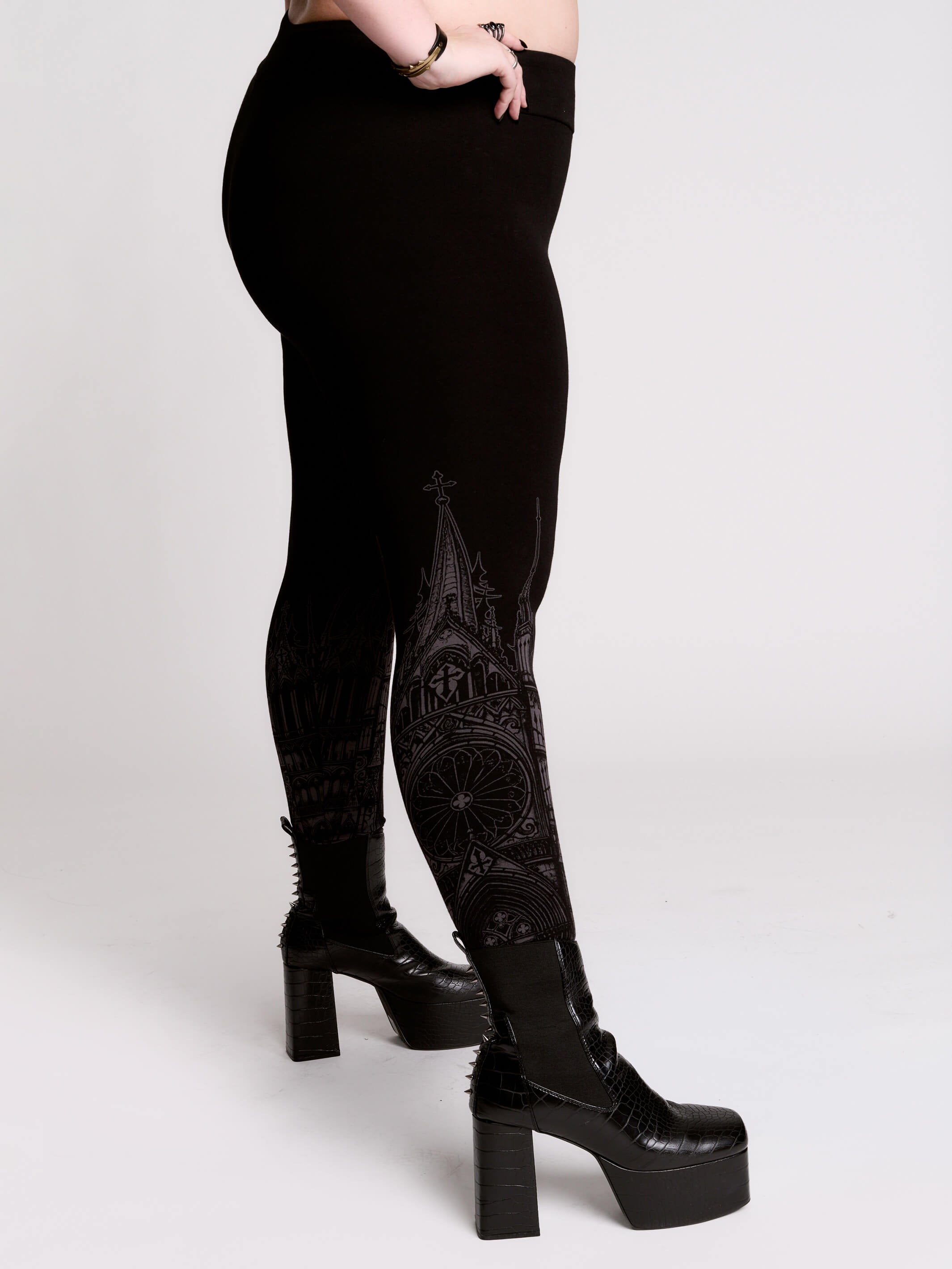 Black leggings with a dark gray gothic cathedral line-art print down the legs.