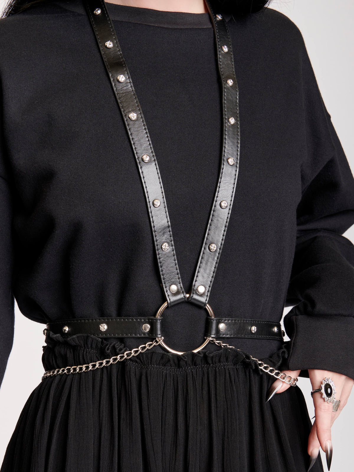 BODY HARNESS WITH SILVER CHAINS AND PU STRAPS STUDDED WITH SILVER RIVETS JOIN BY AN O-RING AT CENTER FRONT