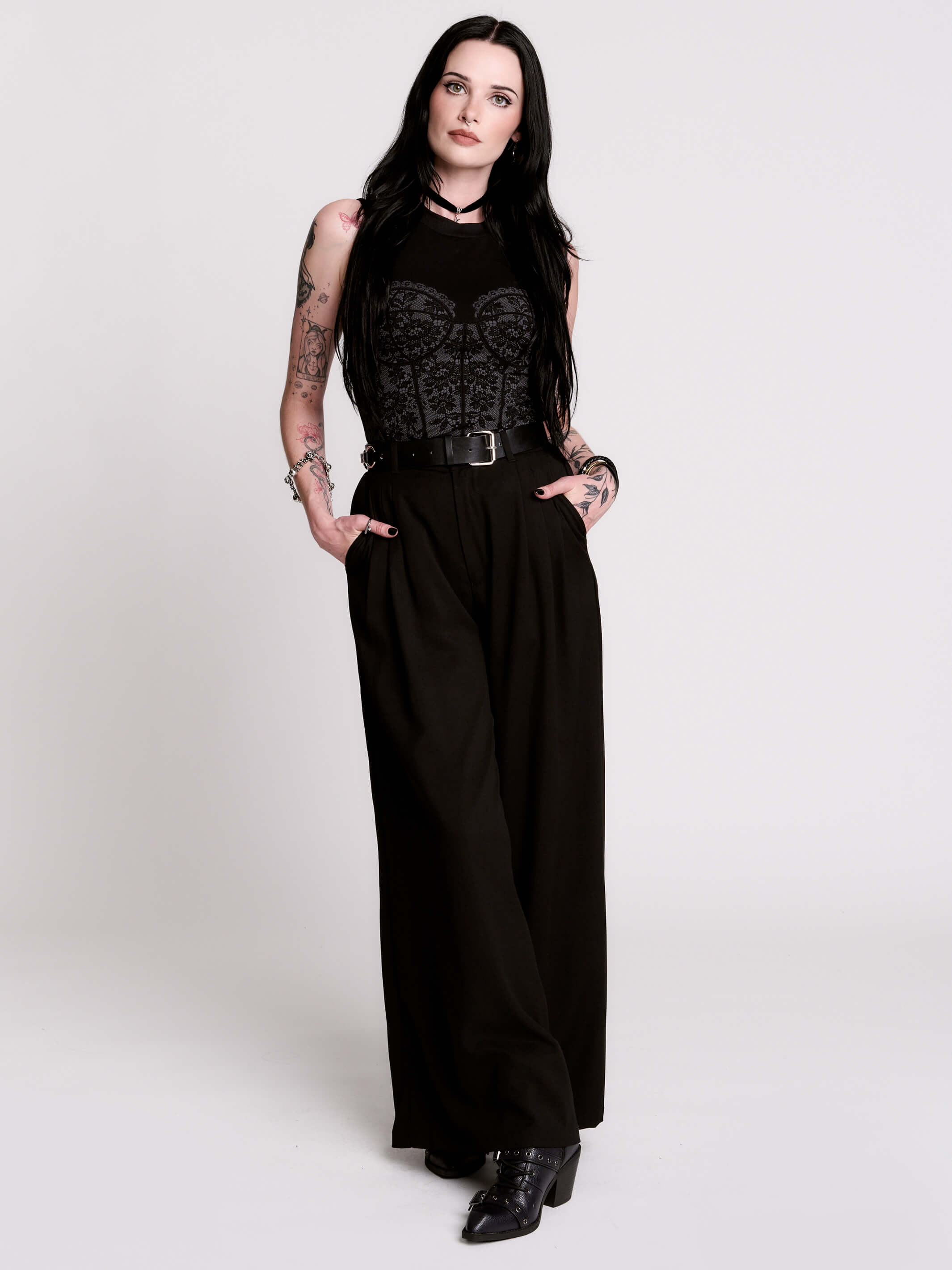 A black sleeveless top with a printed floral lace corset in light grey.