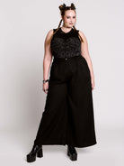 A black sleeveless top with a printed floral lace corset in light grey.