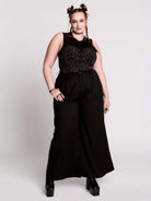 A black sleeveless top with a printed floral lace corset in light grey.