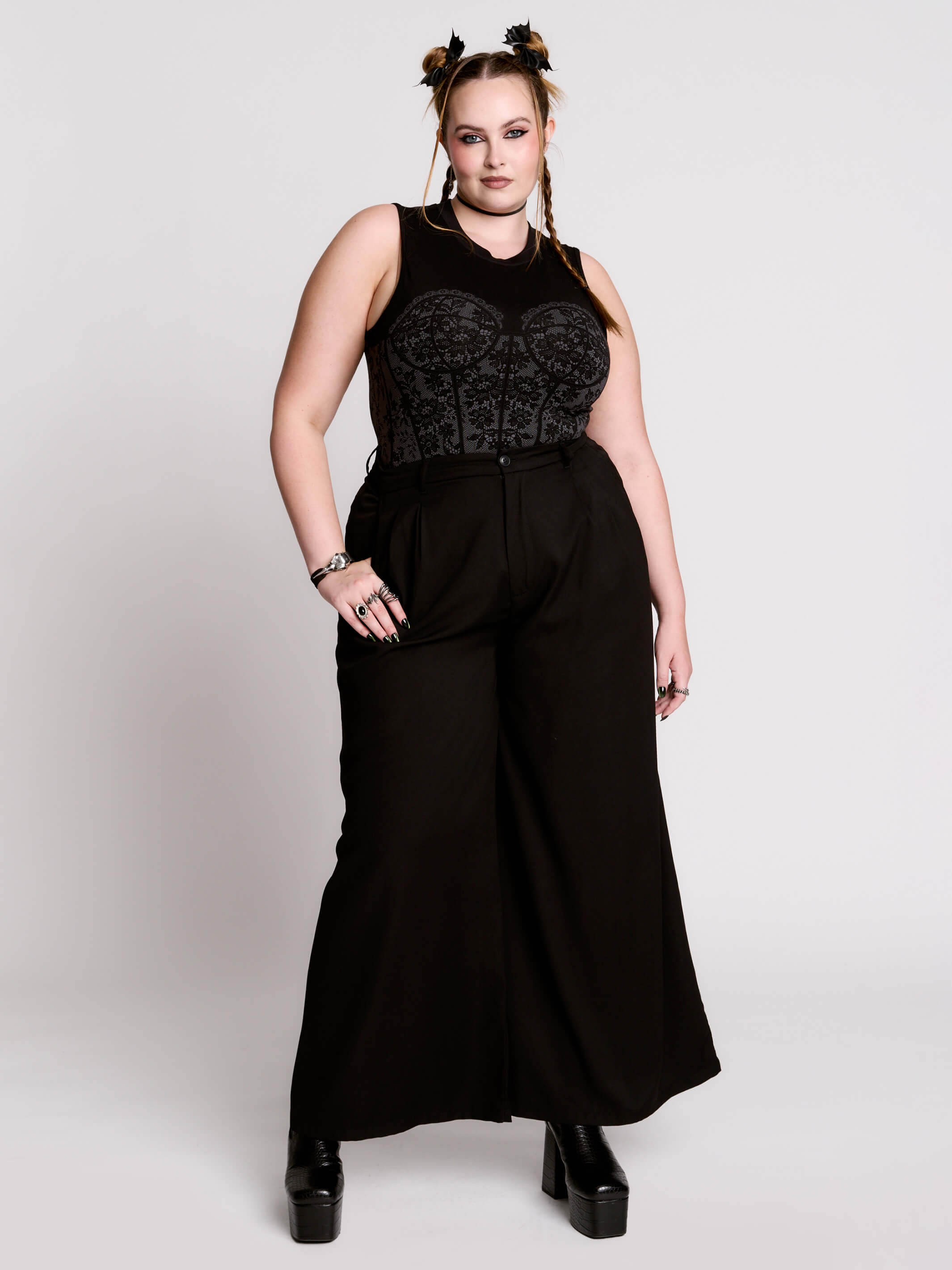 A black sleeveless top with a printed floral lace corset in light grey.