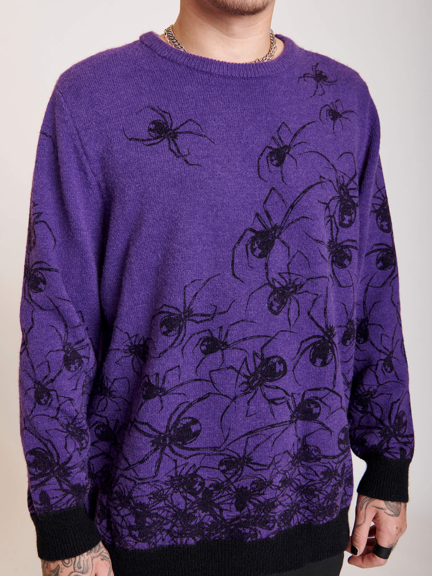  purple sweater with spiders all over