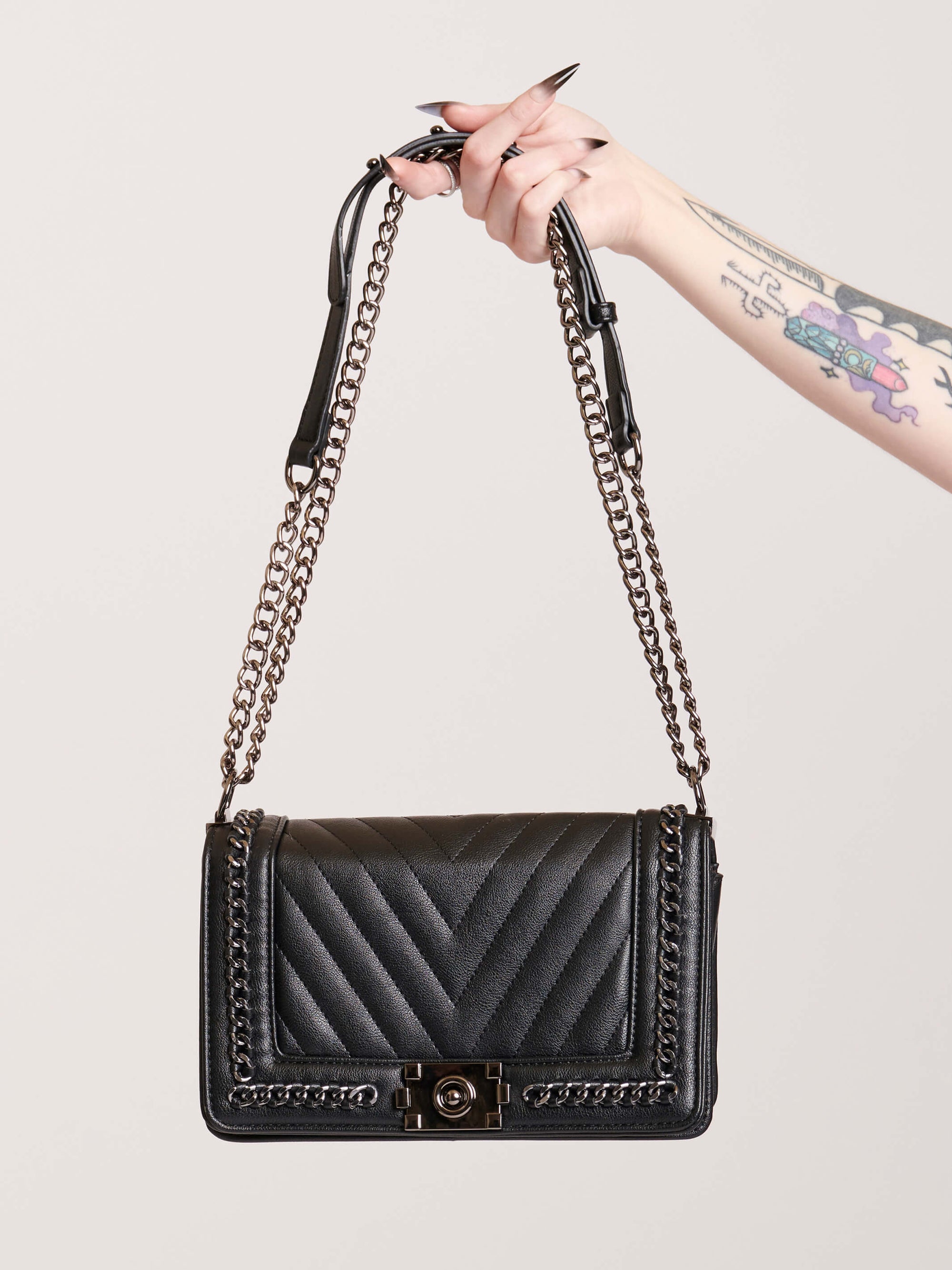 Black quilted purse with silver chain detail