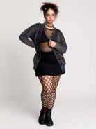 a dark gray textured cardigan with braided details